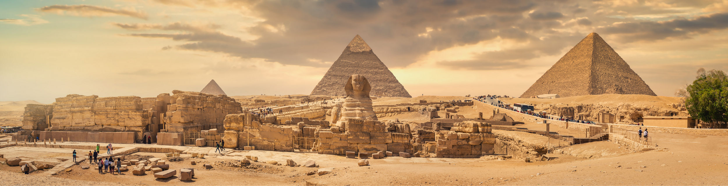 Panoramic view of Giza pyramids at sunset
