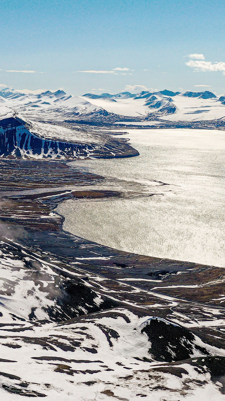 Snowy mountain landscape with coastal view