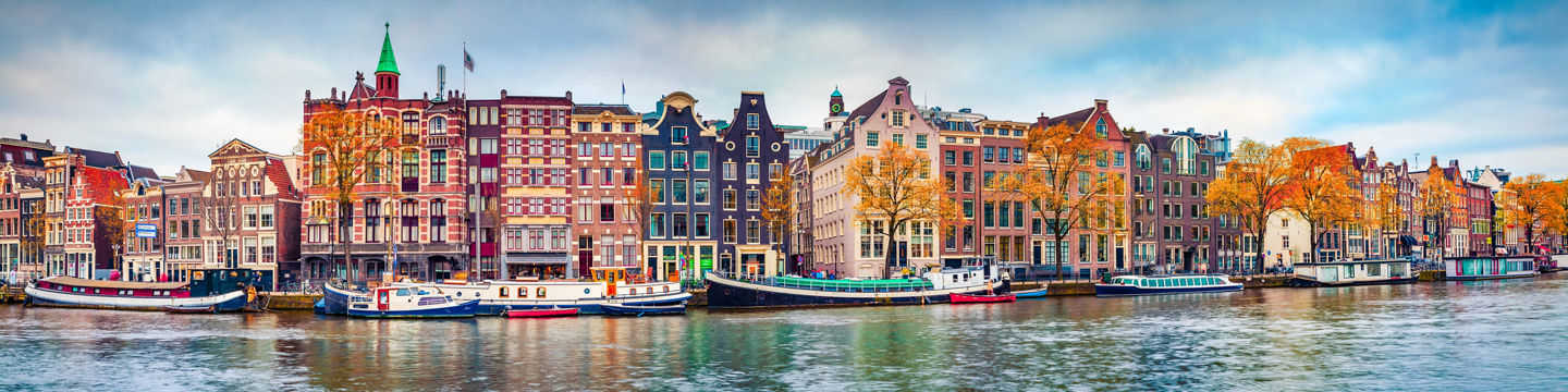 Colorful Amsterdam canal with autumn trees