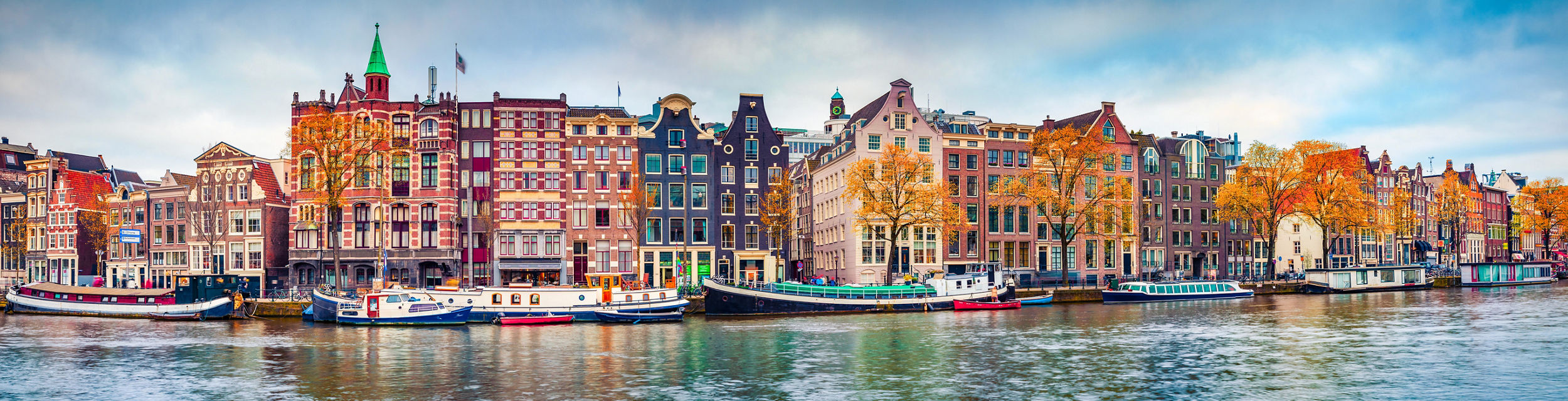 Colorful Amsterdam canal with autumn trees
