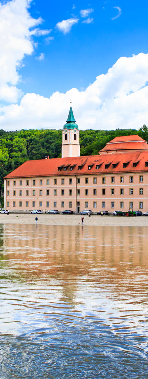 Historic riverside monastery with red roofs