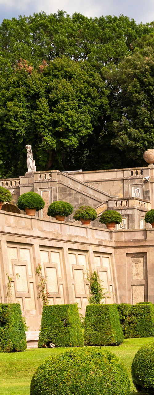 Elegant garden with statues and hedges