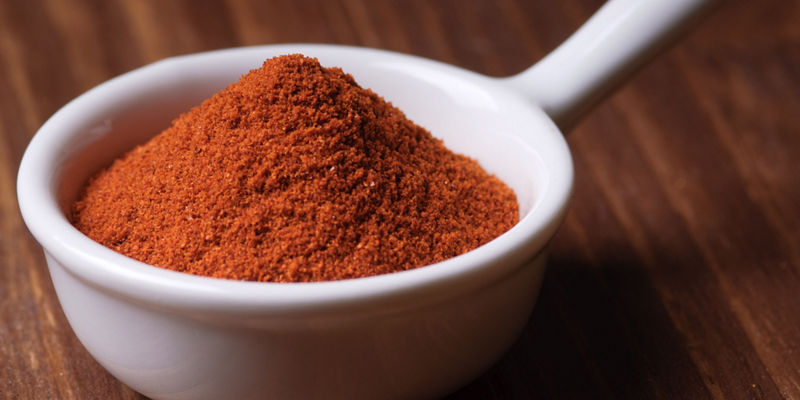 Scoop of Ground Red Spice on Table