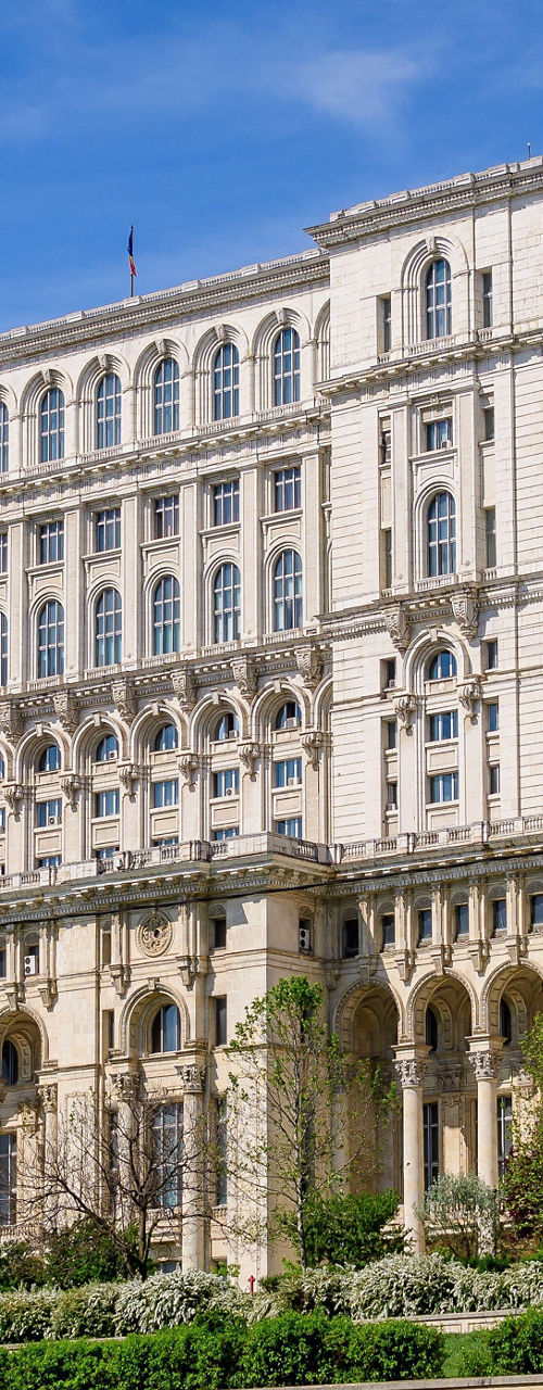Grand architectural building with lush greenery