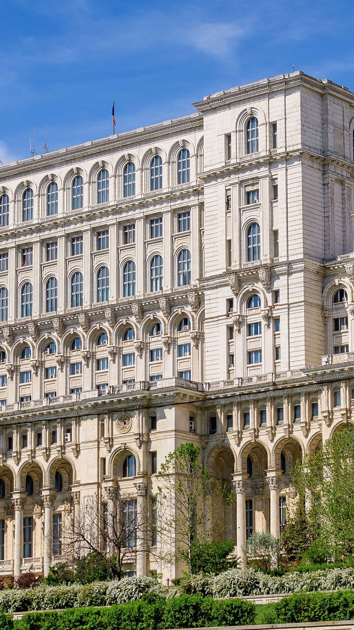 Grand architectural building with lush greenery