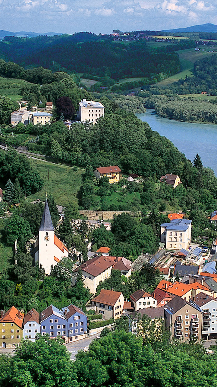 Scenic Riverside Town with Rolling Hills