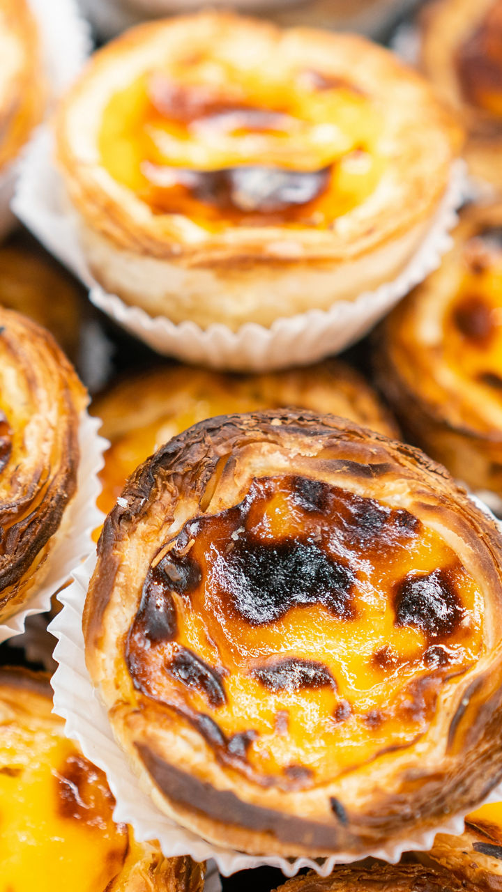 Freshly baked Portuguese custard tarts display