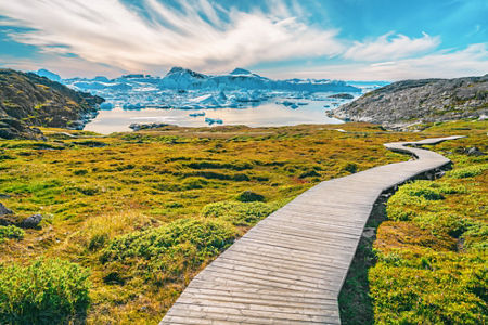 Scenic boardwalk leading to icy lake