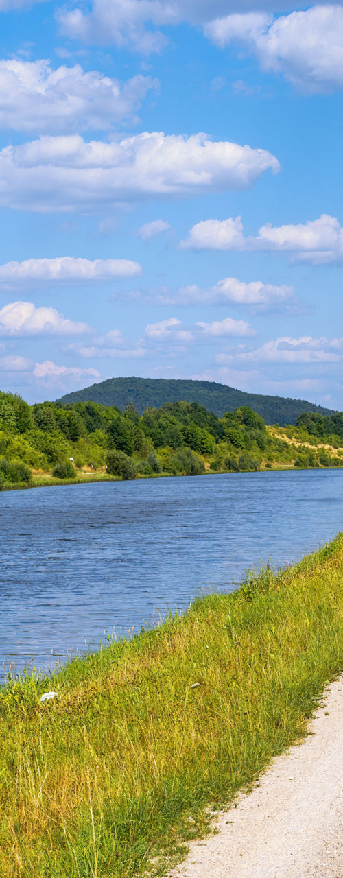 Scenic riverside path under blue skies