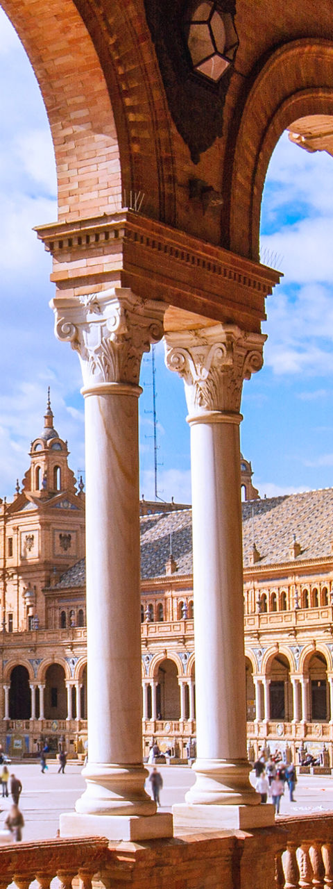 Arched walkway overlooking historic tower