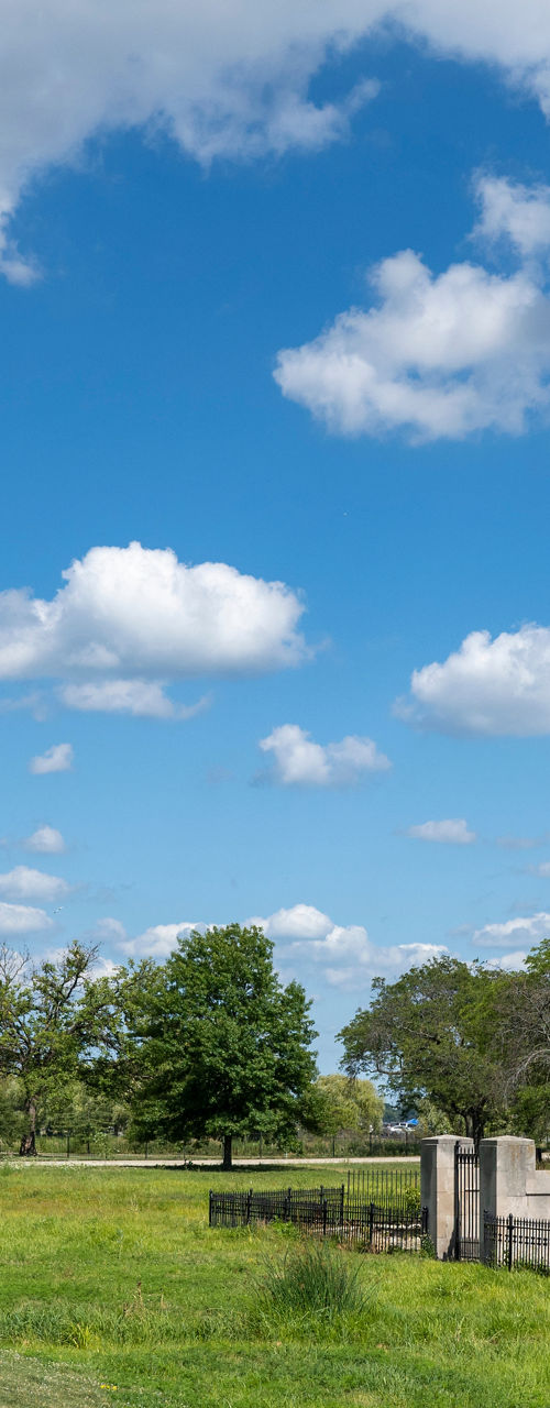Tall stone tower in lush park under blue sky