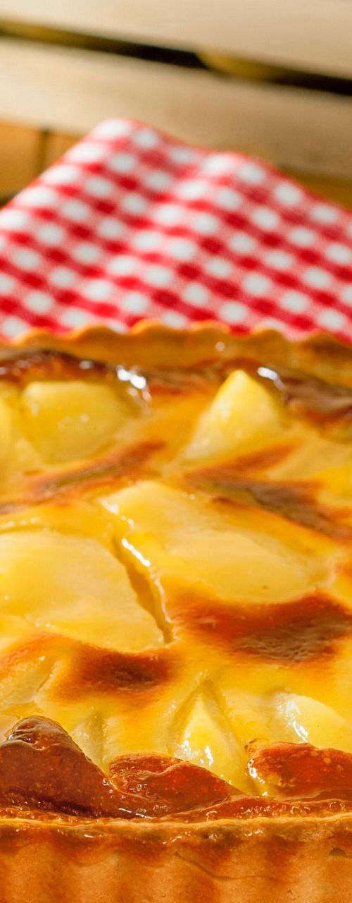 Golden pear tart on red checkered cloth