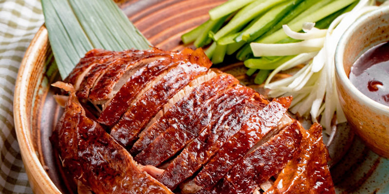Sliced roasted duck with fresh vegetables