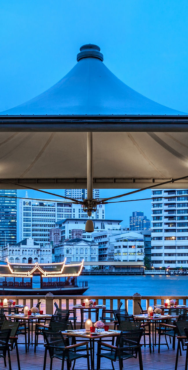 Riverside dining area with cityscape view