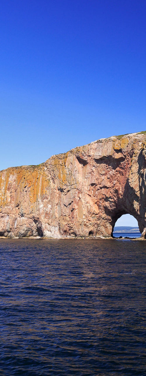 Perce Rock in clear blue waters