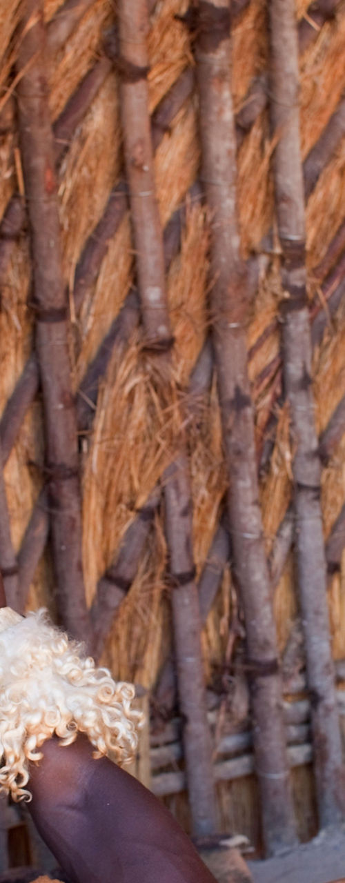 Traditional attire in rustic hut setting