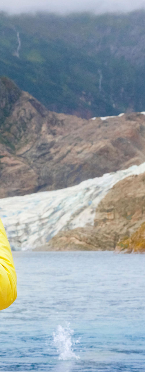 Woman photographing glacier in outdoor setting