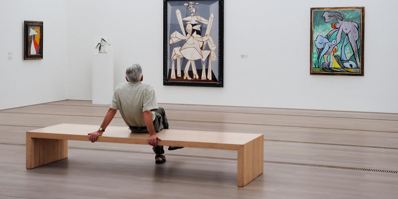 Man observing modern art in gallery