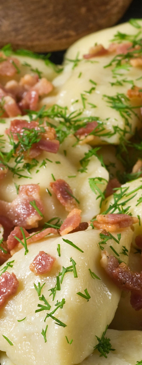 Pan of dumplings with bacon and herbs