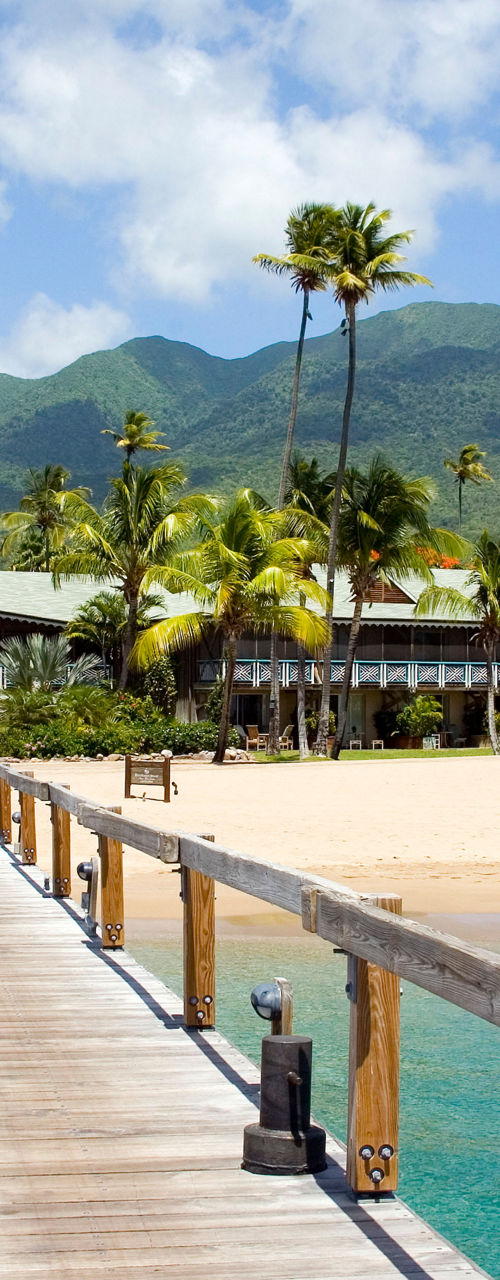 Tropical pier leading to lush island resort