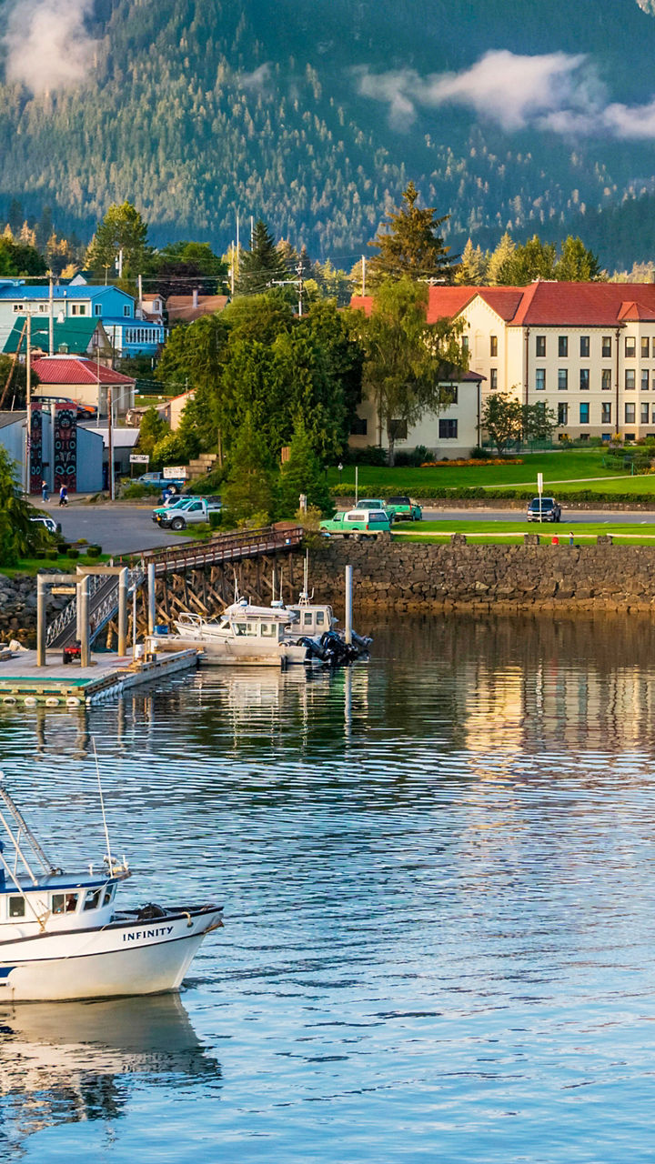 Scenic harbor town with mountain backdrop