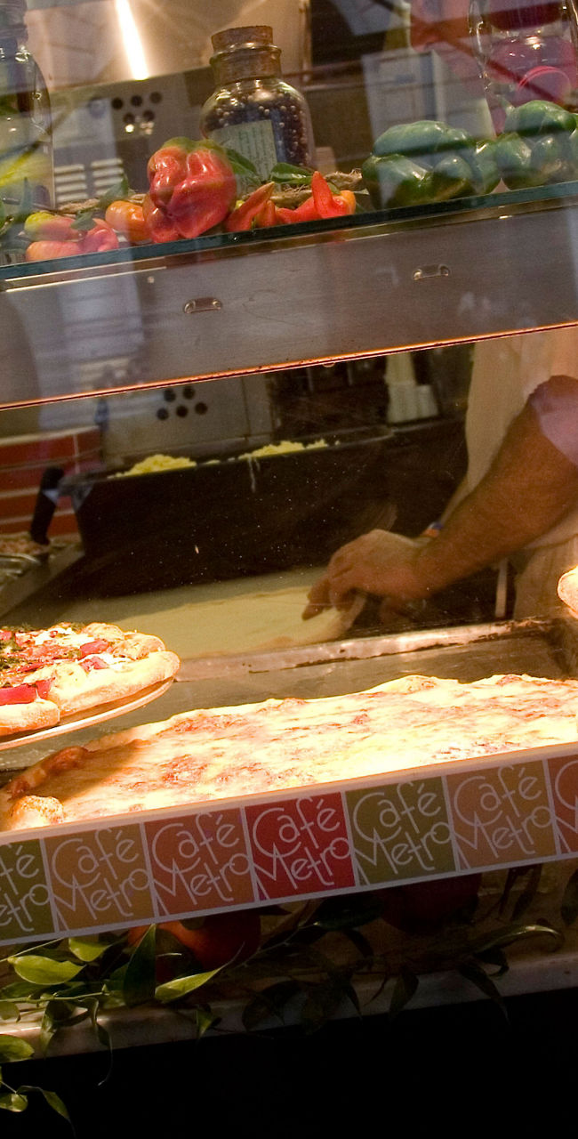 Fresh pizzas displayed in restaurant window