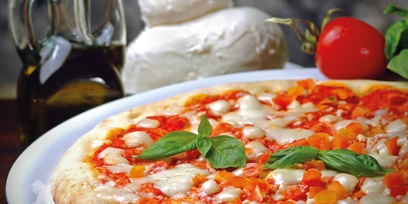 Freshly baked pizza with basil garnish