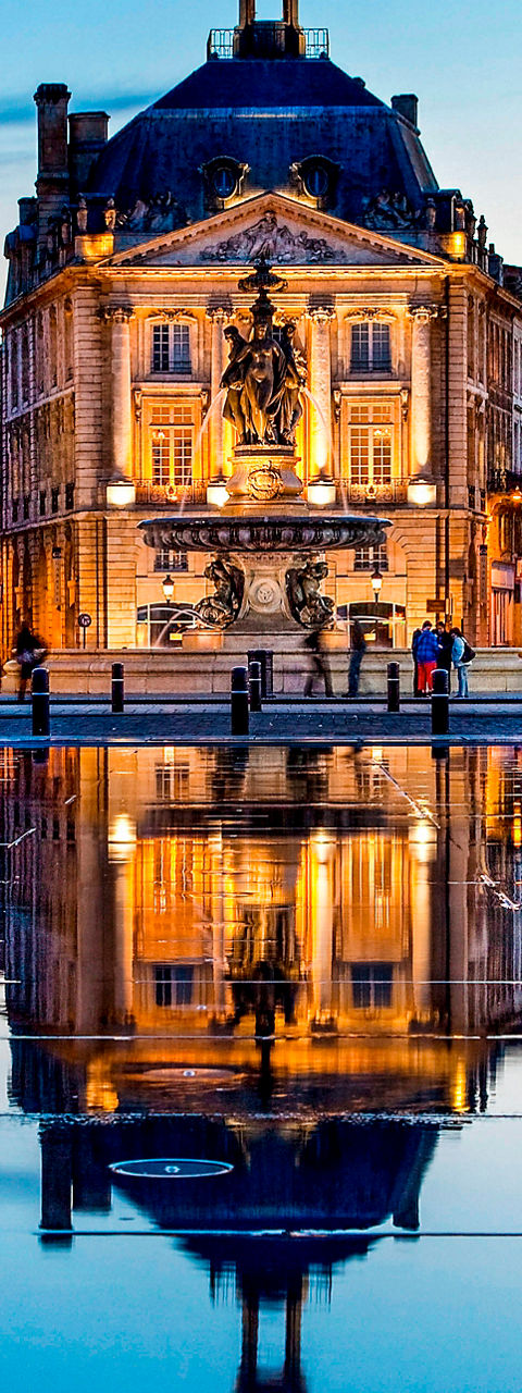 Historic Bordeaux buildings at sunset reflection