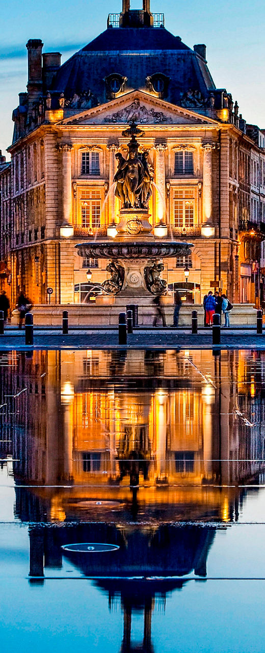 Historic Bordeaux buildings at sunset reflection