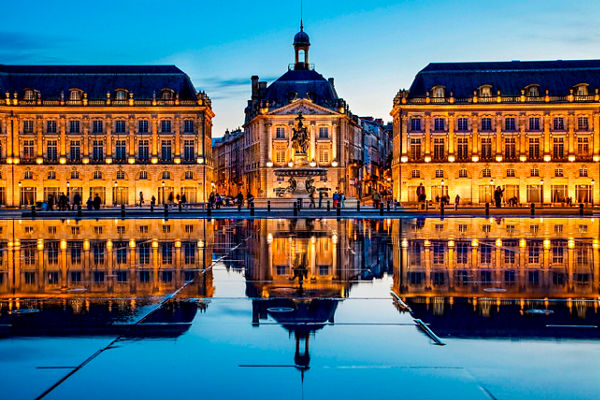 Historic Bordeaux buildings at sunset reflection