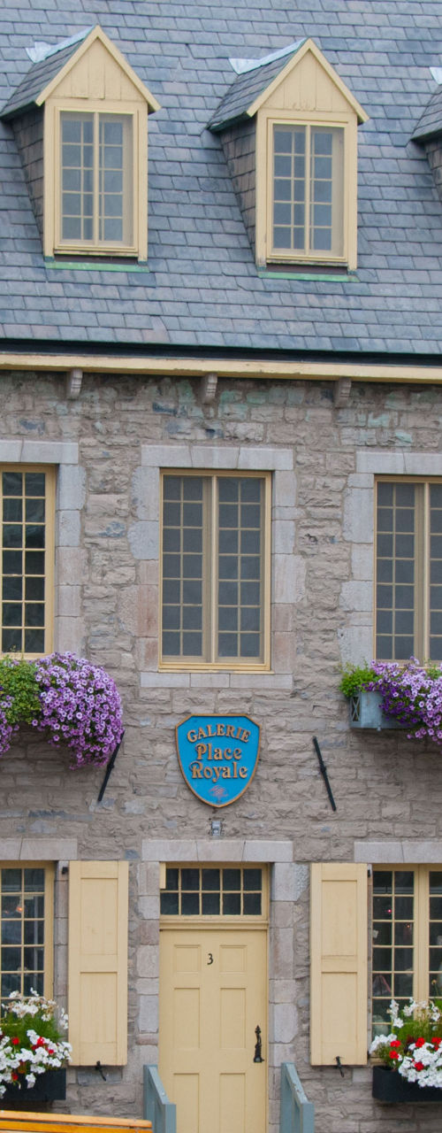 Historic stone buildings with colorful flowers