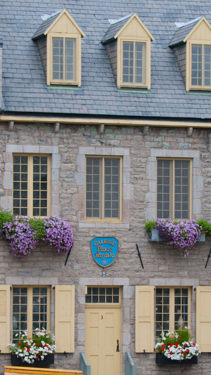 Historic stone buildings with colorful flowers