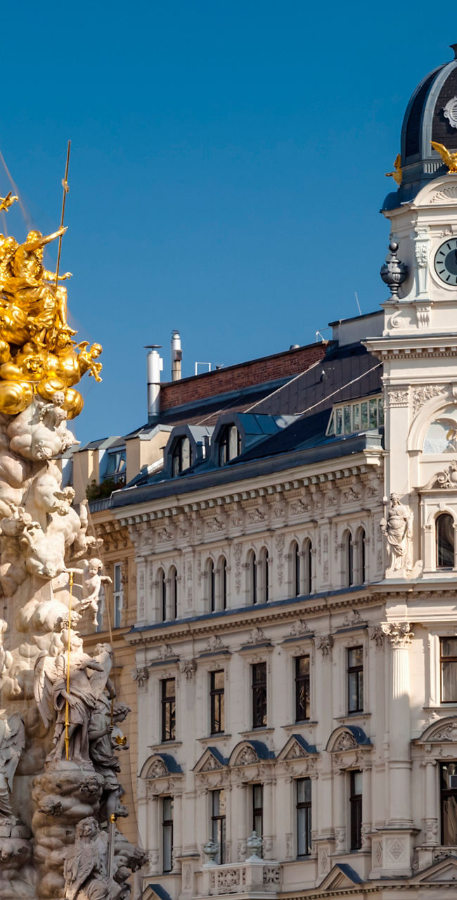 Historic European architecture with golden monument