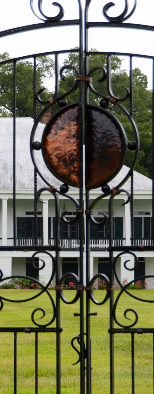 Elegant wrought iron gate with mansion view