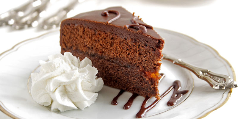 Slice of chocolate cake with whipped cream