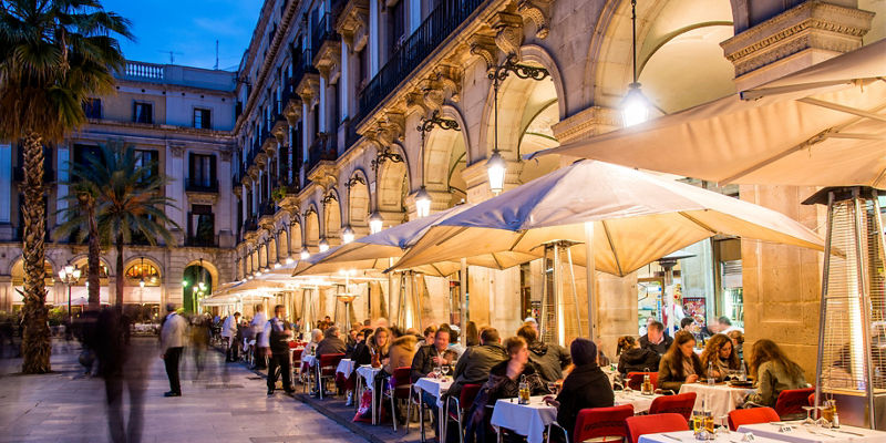 Outdoor dining at European plaza at dusk