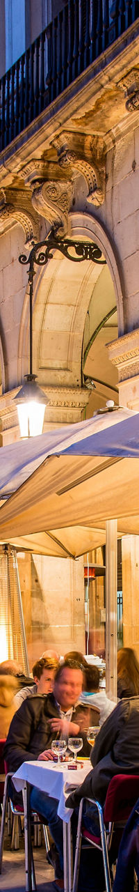 Outdoor dining at European plaza at dusk