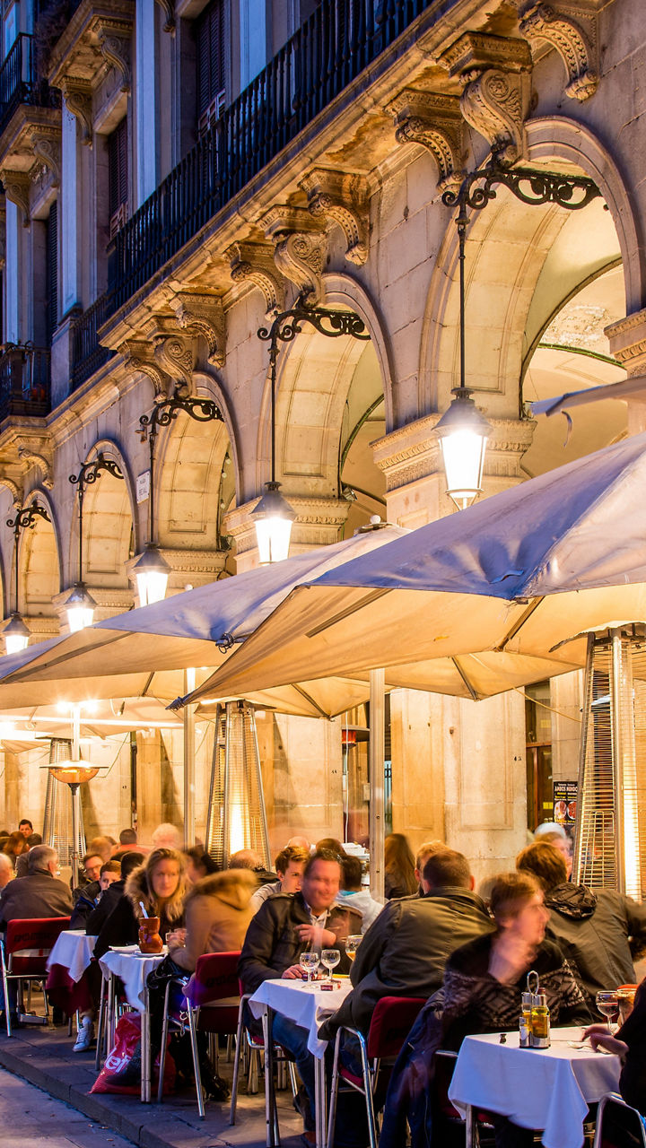 Outdoor dining at European plaza at dusk
