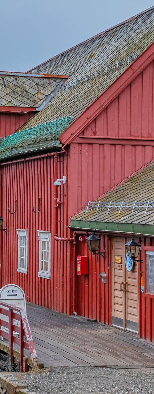 Red waterfront buildings in harbor setting