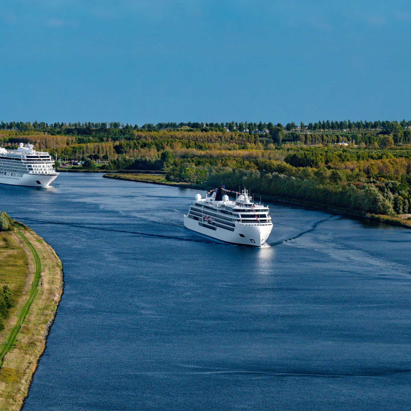 Cruise ships sailing on scenic river