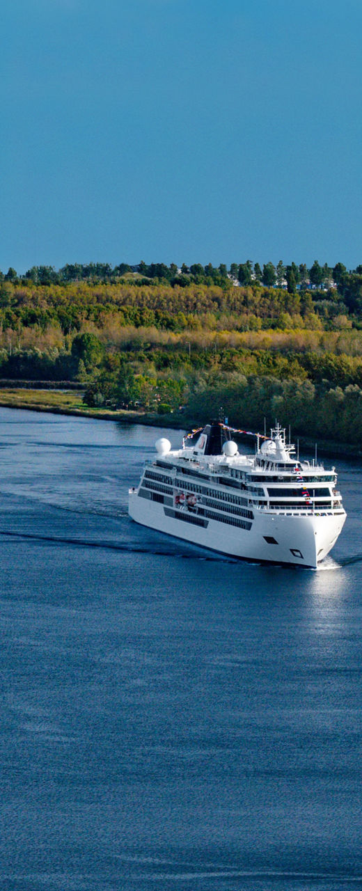 Cruise ships sailing on scenic river