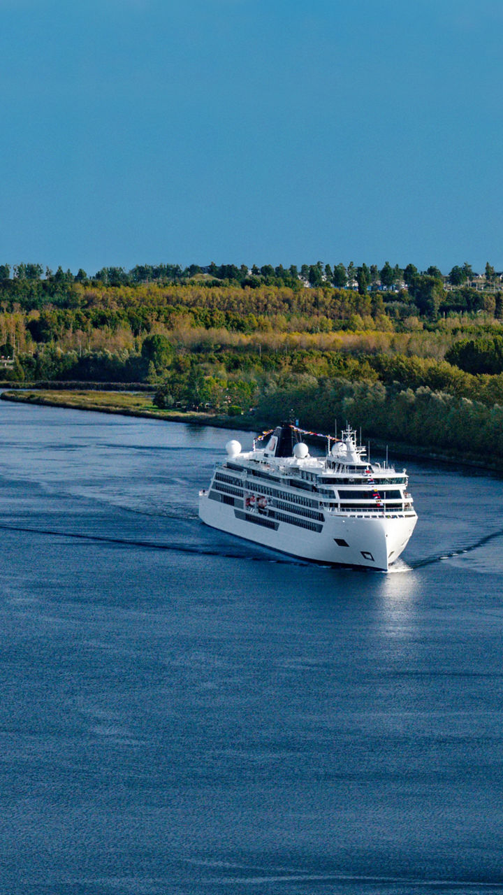 Cruise ships sailing on scenic river