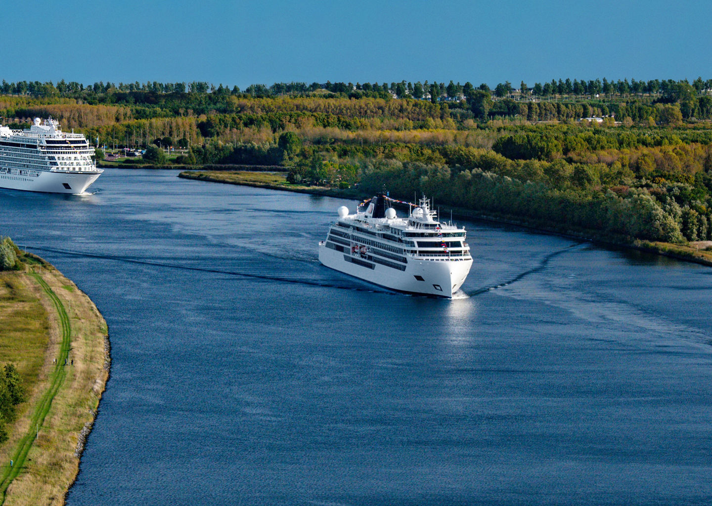 Cruise ships sailing on scenic river