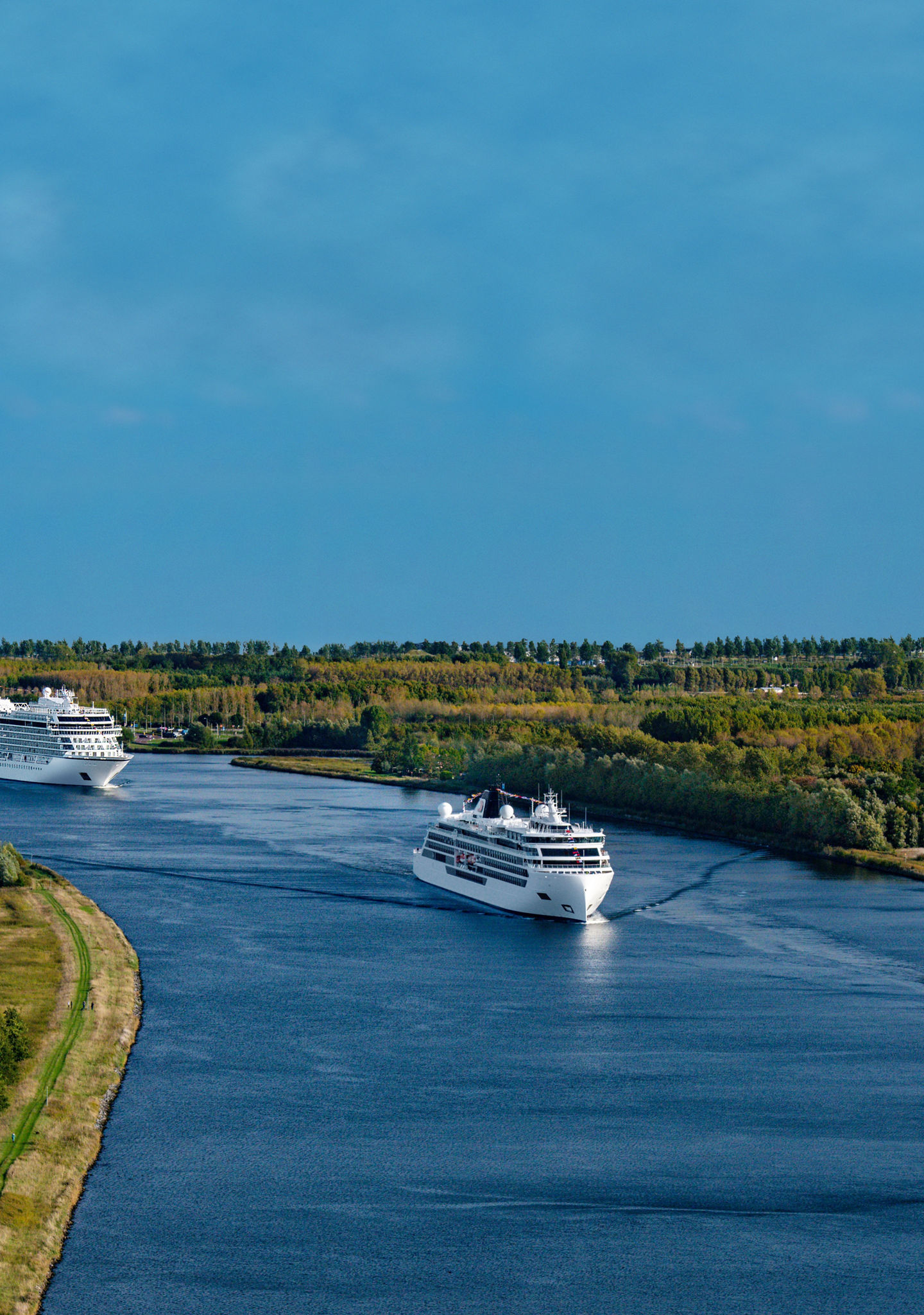 Cruise ships sailing on scenic river