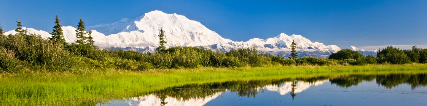 Snowy mountain reflected in serene lake