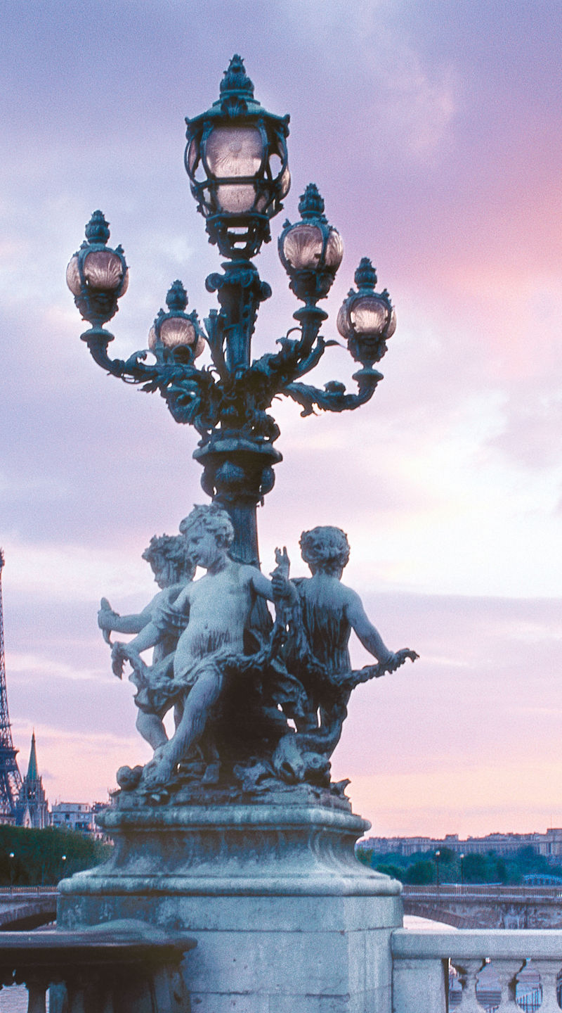 Eiffel Tower and ornate bridge at sunset