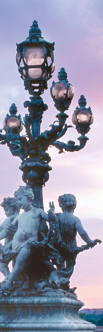 Eiffel Tower and ornate bridge at sunset