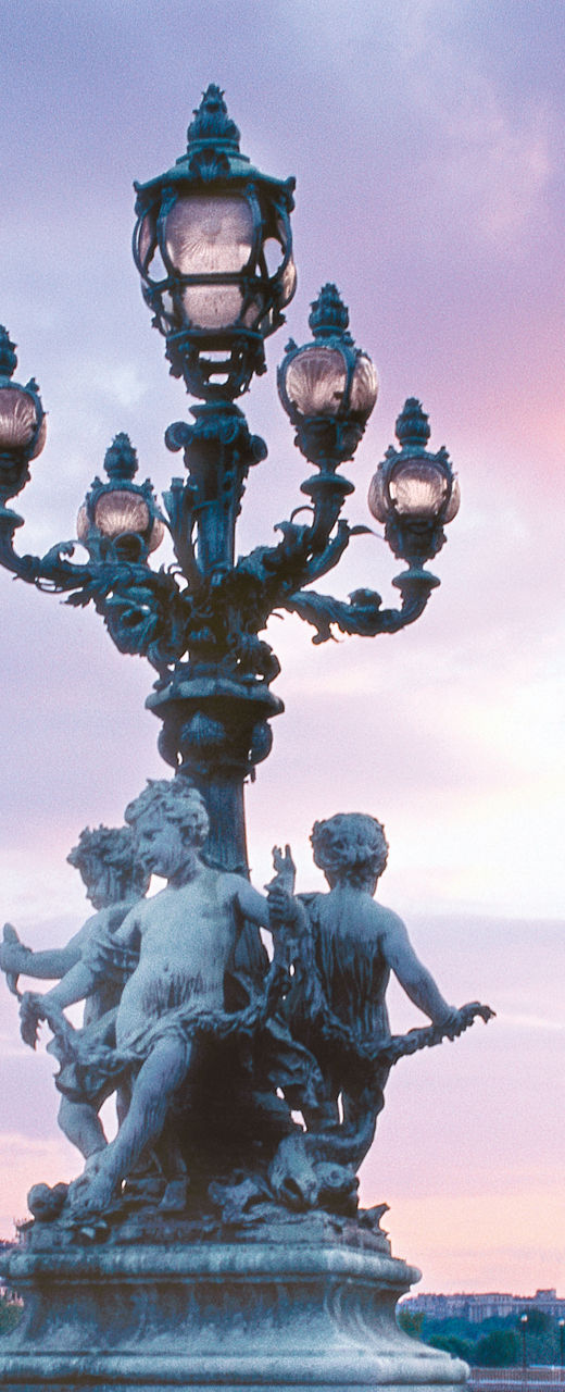 Eiffel Tower and ornate bridge at sunset