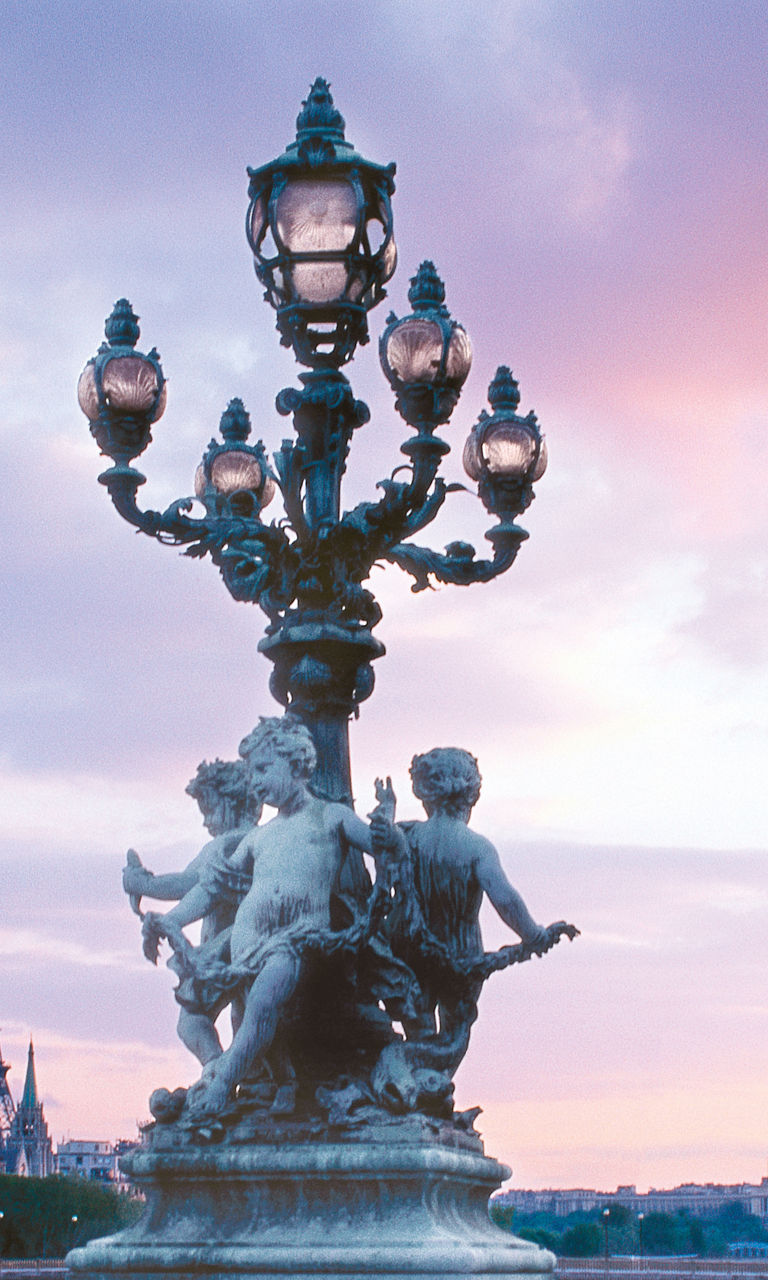 Eiffel Tower and ornate bridge at sunset