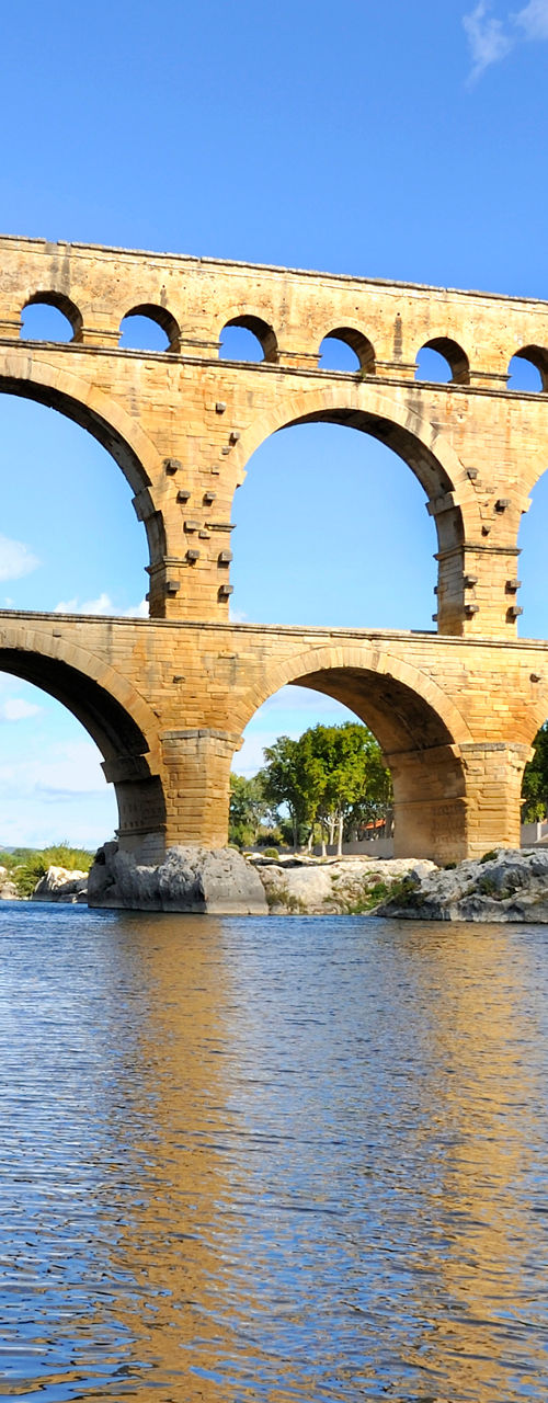 Historic Roman aqueduct over scenic river